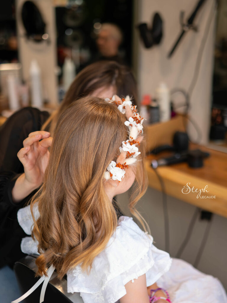 Inspiration Mariage P&F la coiffeuse peaufine les derniers détails dans la chevelure de la demoiselle d'honneur